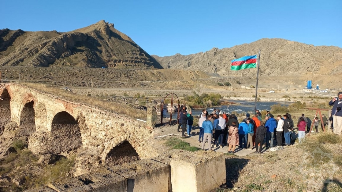 International travelers familiarize themselves with Khudafarin Bridge